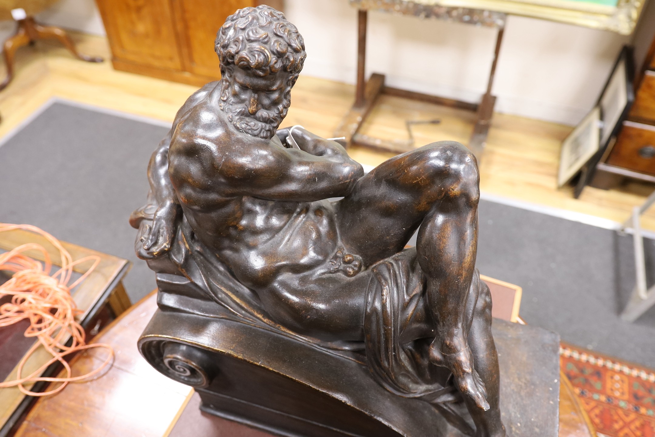 A pair of large classical composition reclining figures, 57 cm high